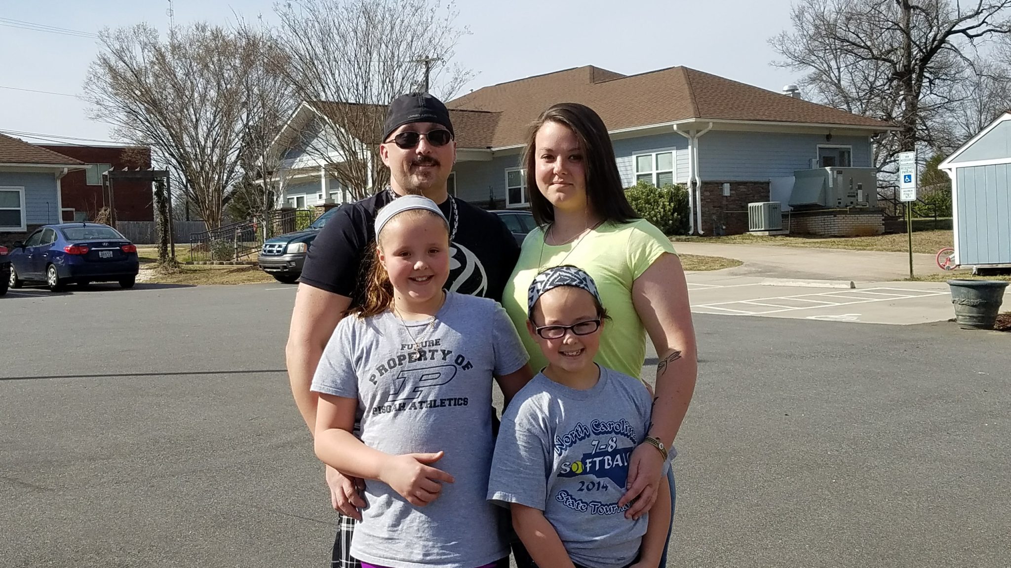 Woman in our reentry program at the Center for Women poses with her family, just reunited.